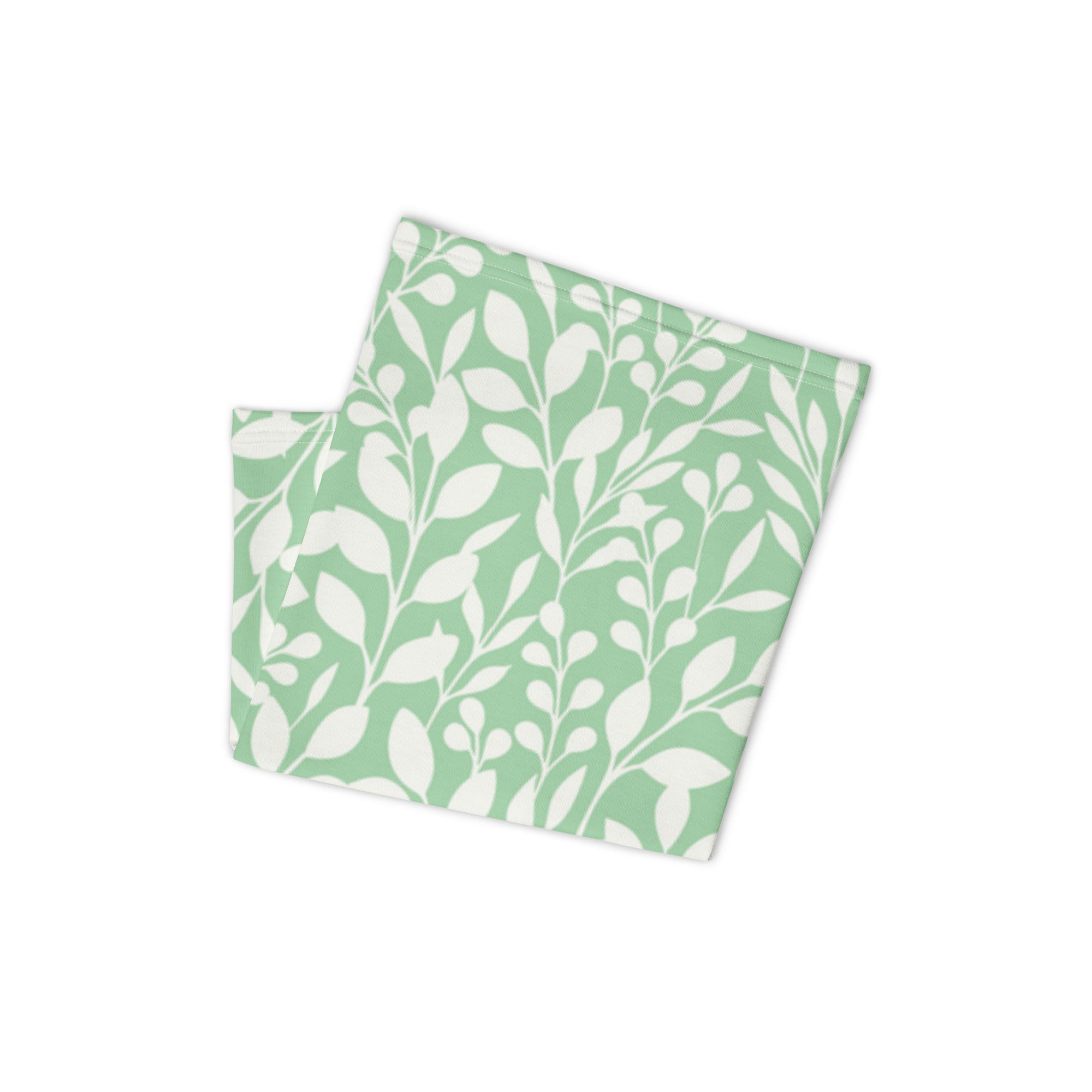 Folded mint green Casting Queens fishing neck gaiter featuring white floral pattern design, lightweight women’s fishing apparel accessory for sun protection and outdoor adventures.